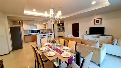 Spacious open-plan living and dining area with modern kitchen in a stylish apartment.