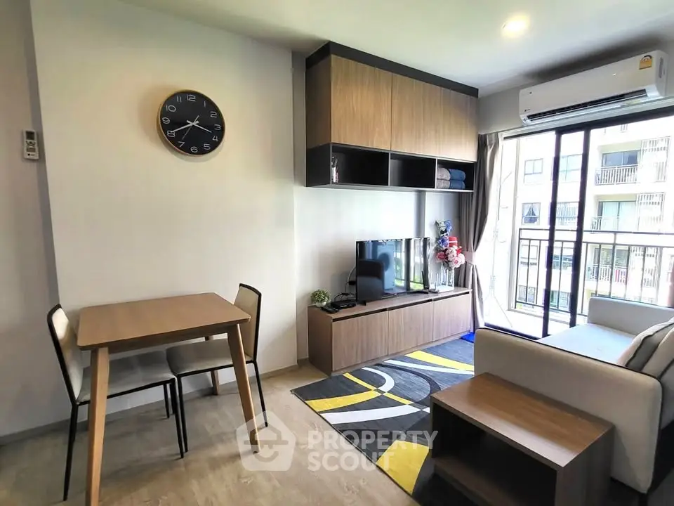 Modern living room with stylish furniture and balcony view in a cozy apartment.