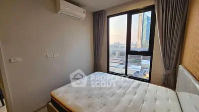 Modern bedroom with city view and air conditioning in high-rise apartment
