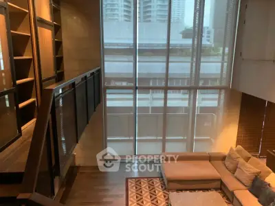 Spacious modern living room with high ceilings and large windows offering city views.