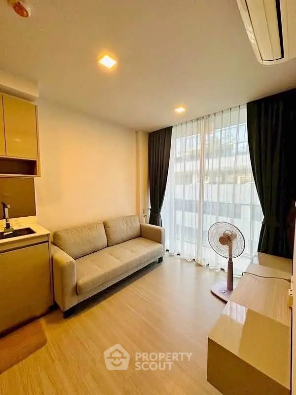 Modern living room with cozy sofa and large window in stylish apartment