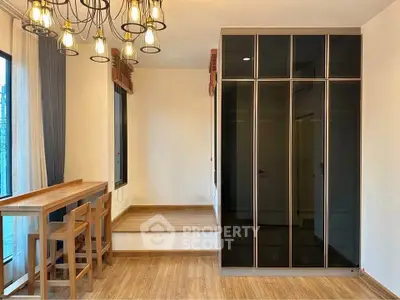 Modern interior with elegant lighting and sleek storage in a cozy living space.