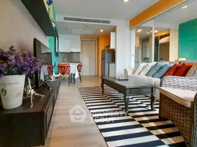 Modern living room with stylish decor and open kitchen layout in a cozy apartment.