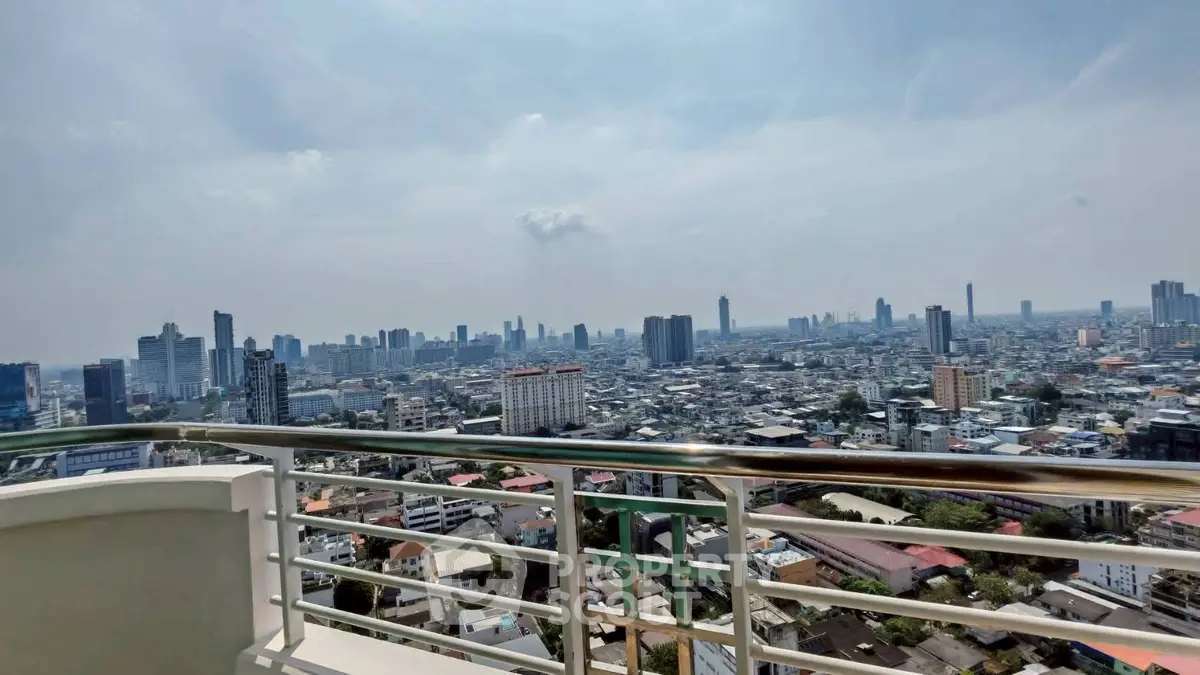 Stunning cityscape view from a high-rise balcony showcasing urban skyline and expansive horizon.