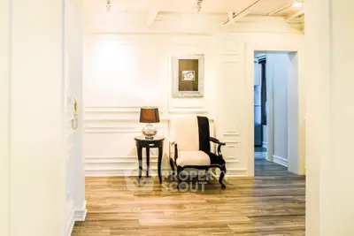 Elegant hallway with classic chair and side table in luxury home