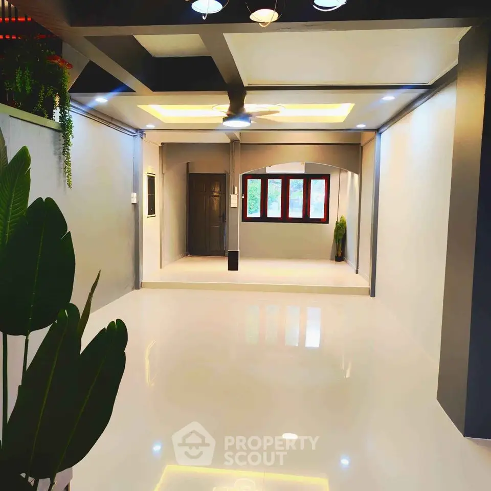 Spacious modern living room with sleek design and large windows for natural light.