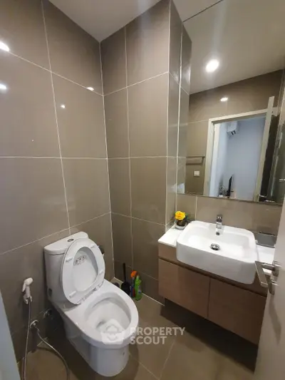 Modern bathroom with sleek fixtures and neutral tiles