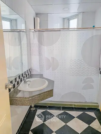 Modern bathroom with geometric tiles and stylish sink design