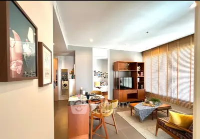 Stylish living room with modern furniture and open layout, featuring a cozy dining area and natural light.