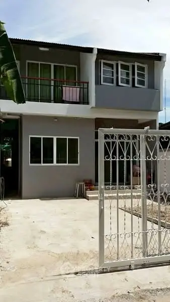 Charming two-story house with gated entrance and modern facade