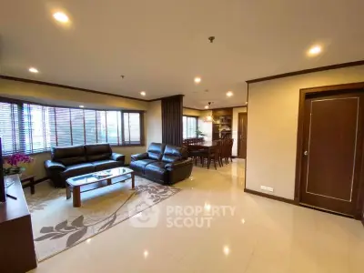 Spacious living room with elegant furniture and dining area in modern apartment.