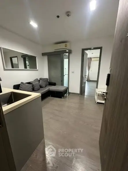 Modern living room with sleek design and comfortable seating in a stylish apartment.