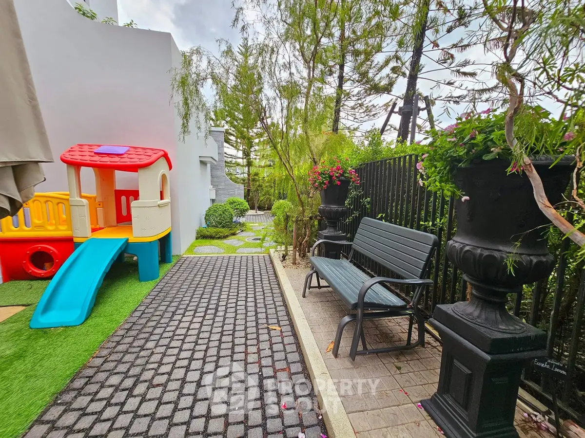 Charming garden with play area and seating, perfect for family relaxation.