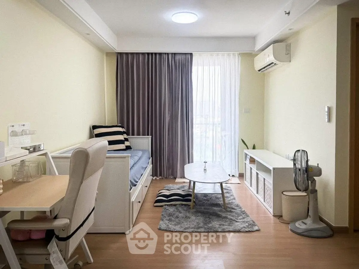 Modern living room with stylish decor, featuring a cozy sofa, elegant curtains, and sleek wooden flooring.