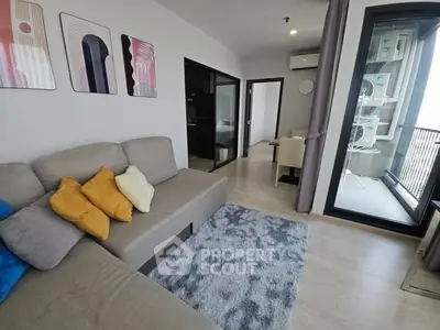 Modern living room with cozy sofa and balcony view in stylish apartment.