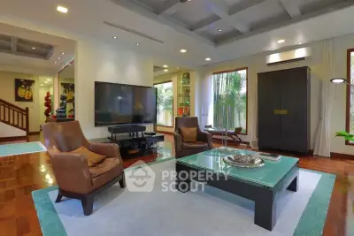 Luxurious living room with modern decor, large TV, and elegant furniture, perfect for relaxation and entertainment.