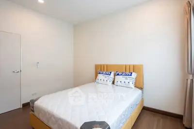 Modern minimalist bedroom with cozy bed and natural light