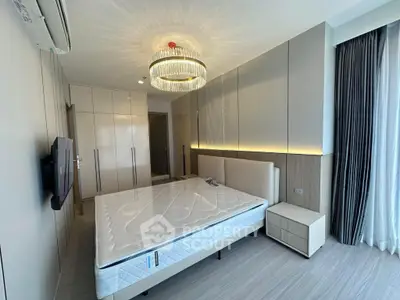 Luxurious bedroom with modern design, featuring elegant lighting and spacious wardrobe.