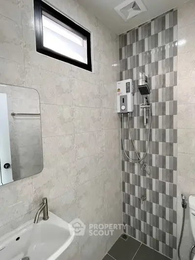 Modern bathroom with stylish shower and sleek sink in contemporary design.