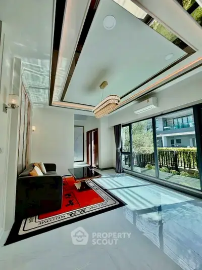Luxurious living room with modern decor and large windows offering garden views.