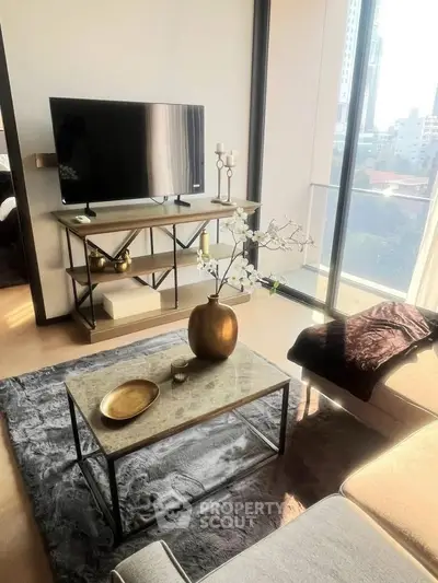Modern living room with stylish decor and city view, featuring a sleek TV stand and elegant coffee table.