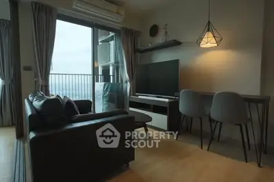 Modern living room with balcony view, stylish furniture, and ambient lighting