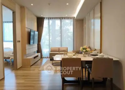 Modern living room with dining area and large windows in stylish apartment