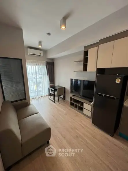 Modern living room with sleek furniture and large window in a stylish apartment.
