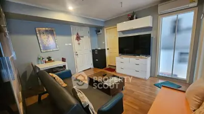 Cozy living room with modern decor and ample natural light, perfect for relaxation and entertainment.