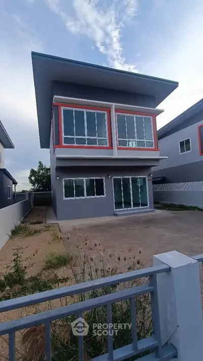 Modern two-story house with sleek design and large windows, perfect for contemporary living.