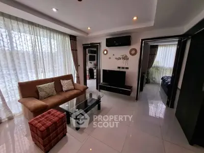 Modern living room with elegant decor and natural light, featuring a cozy sofa and stylish glass coffee table.