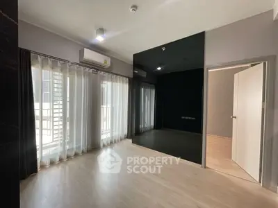 Spacious modern living room with large windows and sleek flooring