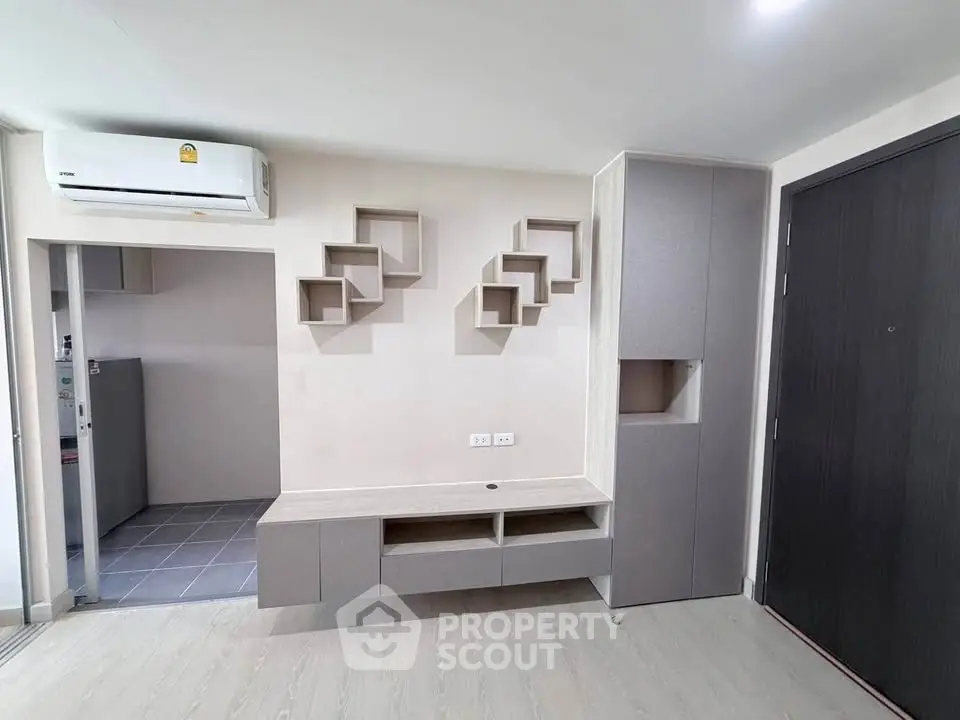 Modern minimalist living room with stylish wall shelves and sleek cabinetry