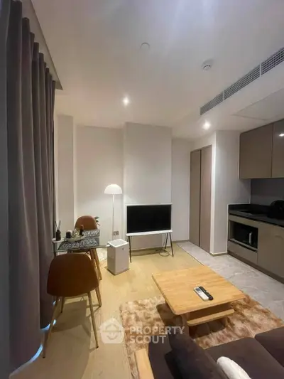 Modern living room with sleek furniture and open kitchen layout