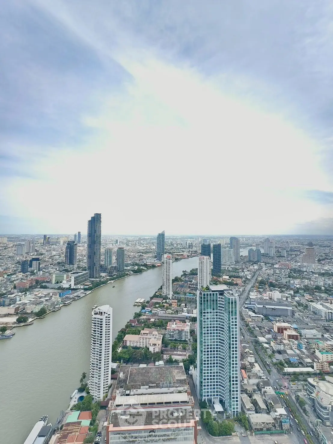 Stunning cityscape view from high-rise building overlooking river and skyline