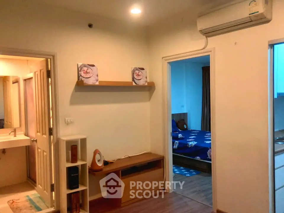 Cozy apartment interior with bedroom and bathroom, featuring modern decor and air conditioning.