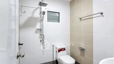 Modern bathroom with sleek fixtures and neutral tiles