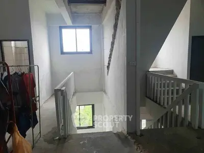 Spacious stairwell with natural light and modern railing design