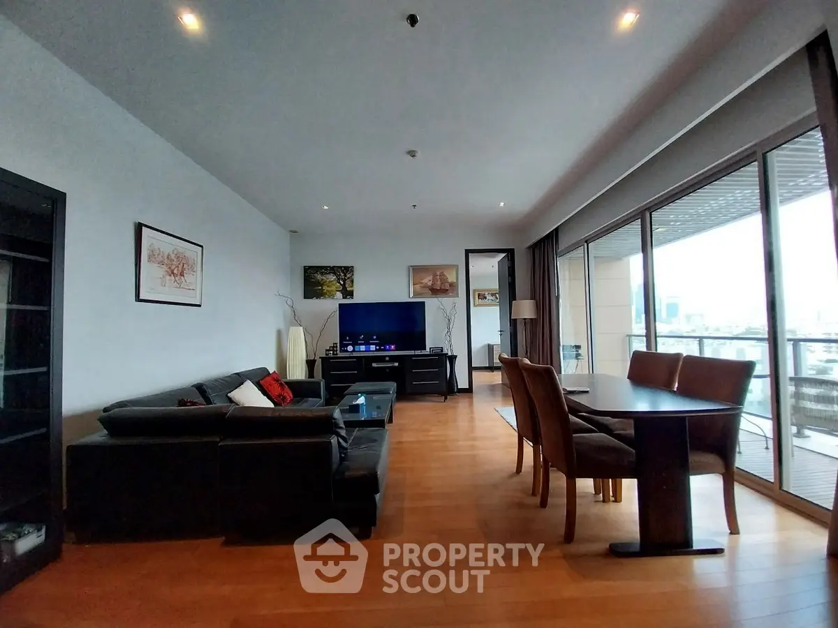 Spacious modern living room with large balcony and city view