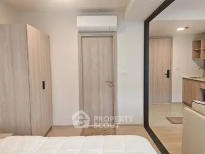 Modern bedroom with wooden wardrobe and air conditioning in a stylish apartment.