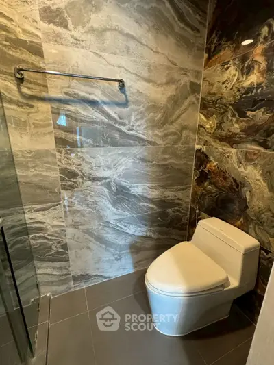 Luxurious bathroom with elegant marble walls and modern toilet design