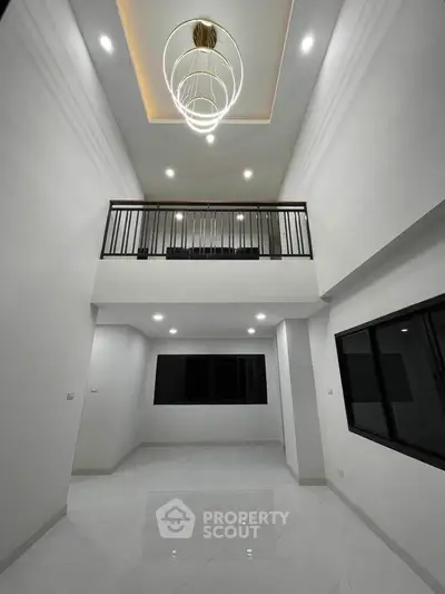 Modern two-story living room with high ceiling and stylish lighting