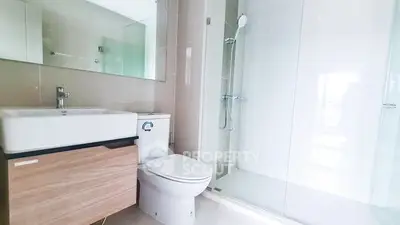Modern bathroom with sleek fixtures and glass shower enclosure