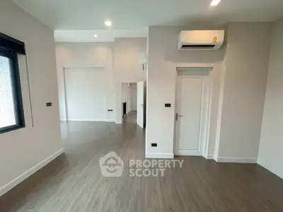 Spacious modern interior with sleek flooring and air conditioning, ideal for versatile living space.