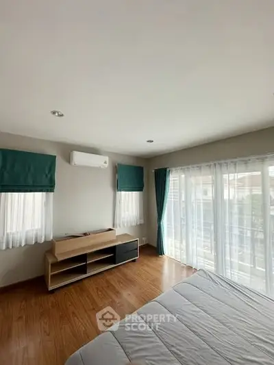 Bright bedroom with large windows and modern furnishings, ideal for natural light lovers.