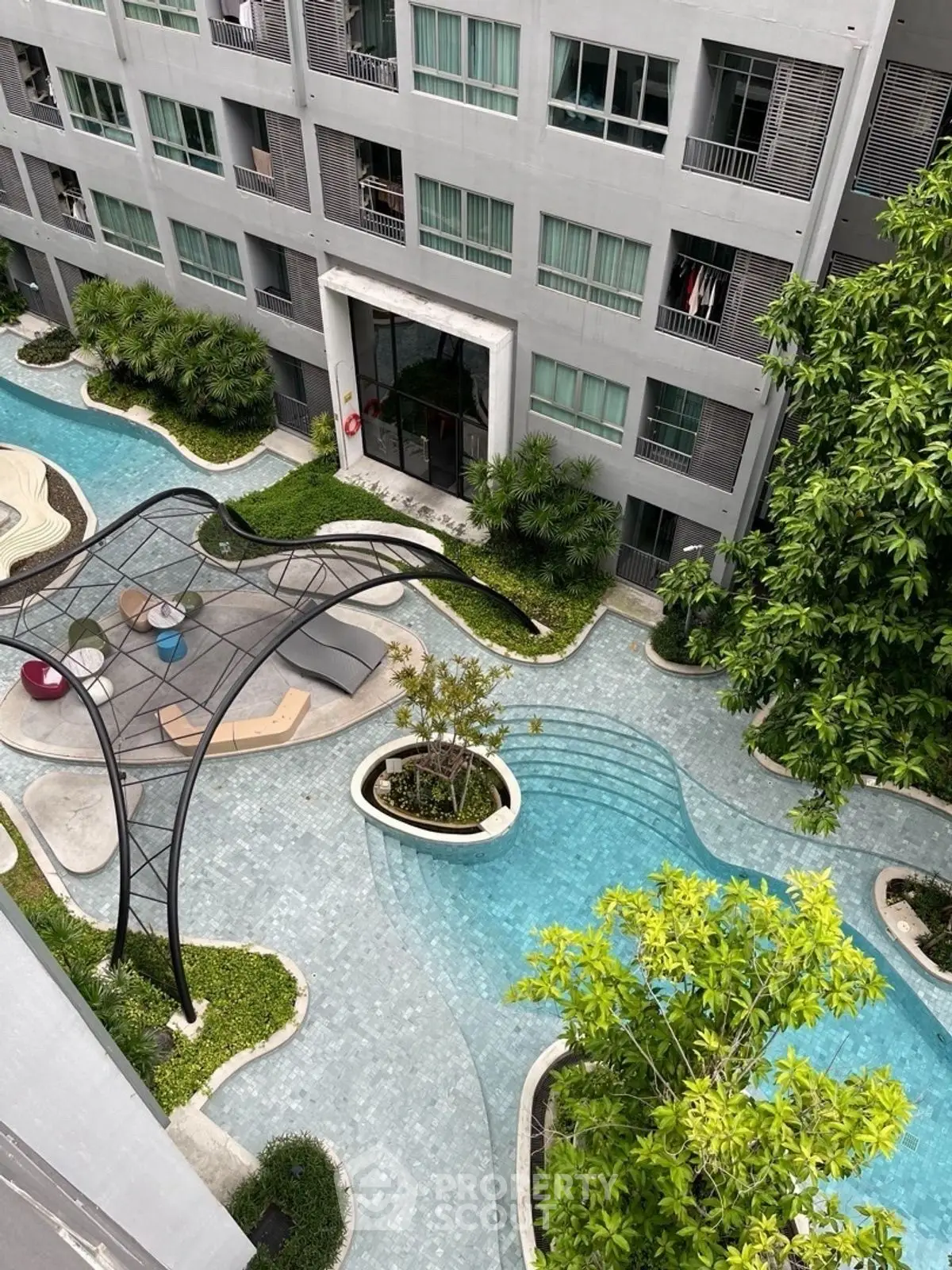 Modern apartment complex with stylish pool and lush landscaping