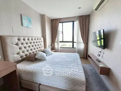 Spacious modern bedroom with large window and wall-mounted TV