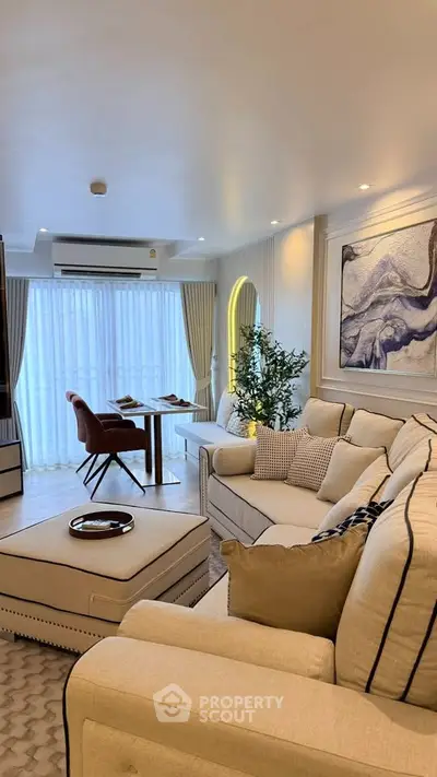 Luxurious living room with elegant decor and large windows offering natural light.