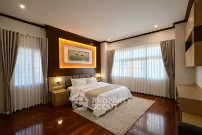 Luxurious bedroom with elegant lighting and hardwood floors