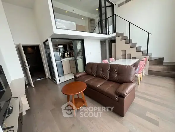 Modern duplex living room with open kitchen and stylish staircase